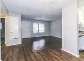 Thumbnail 10 of 36 - an empty living room and kitchen with wood flooring