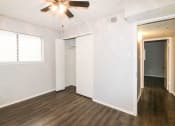 Thumbnail 28 of 36 - an empty living room with white walls and a ceiling fan