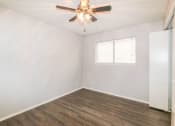 Thumbnail 30 of 36 - an empty bedroom with a ceiling fan and a window