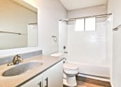 Thumbnail 9 of 36 - a bathroom with a sink and a toilet and a shower