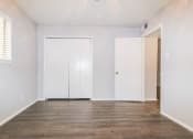 Thumbnail 29 of 36 - an empty living room with white walls and wood floors