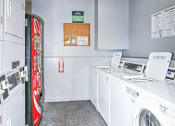 Thumbnail 34 of 36 - a laundry room with washing machines and a coke machine