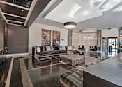 Thumbnail 18 of 20 - A spacious lobby with a marble floor and a large abstract painting on the wall.