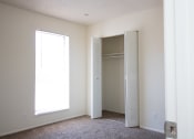 Thumbnail 11 of 11 - a bedroom with a large window and a closet