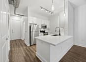 Thumbnail 7 of 38 - A kitchen with white cabinets and a white countertop.