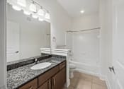 Thumbnail 9 of 38 - A bathroom with a sink, toilet, and bathtub.