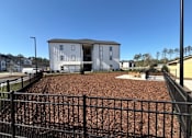 Thumbnail 41 of 41 - A white two-story building with a black fence in front.