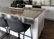 Thumbnail 23 of 36 - a kitchen with white cabinets and a granite counter top