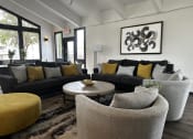 Thumbnail 24 of 36 - a living room with couches and chairs and a coffee table