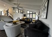 Thumbnail 26 of 36 - a living room with couches and chairs and a staircase