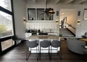 Thumbnail 28 of 36 - a kitchen and dining room with a marble table and chairs