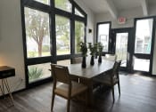 Thumbnail 30 of 36 - a dining room with a table and chairs and large windows