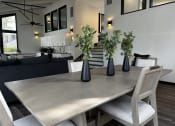 Thumbnail 31 of 36 - a dining room with a table and chairs and vases