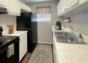 Thumbnail 5 of 29 - a kitchen with a sink and a refrigerator