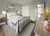 Thumbnail 6 of 29 - a bedroom with a bed and a door to a bathroom