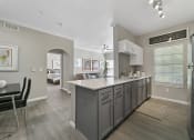 Thumbnail 2 of 32 - a kitchen with a large island and a dining room in the background