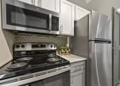 Thumbnail 3 of 32 - a kitchen with white cabinets and stainless steel appliances