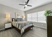 Thumbnail 9 of 32 - a bedroom with a large window and a ceiling fan