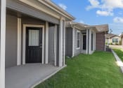 Thumbnail 17 of 29 - a home with a black door and a sidewalk in front of it