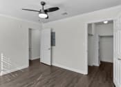 Thumbnail 24 of 29 - an empty room with white walls and a ceiling fan