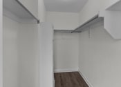 Thumbnail 25 of 29 - an empty room with white walls and a wood floor
