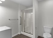 Thumbnail 26 of 29 - an empty bathroom with a shower and a toilet