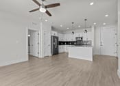 Thumbnail 21 of 24 - A spacious kitchen with a ceiling fan and pendant lights.
