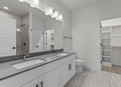 Thumbnail 22 of 24 - A bathroom with a white sink and a white toilet.