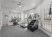 Thumbnail 13 of 30 - A spacious home gym with a variety of exercise equipment.