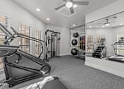 Thumbnail 8 of 30 - A well-equipped home gym with a treadmill, weights, and mirrors.