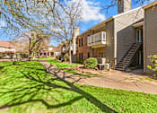 Thumbnail 23 of 30 - A sunny day in a quiet residential area with apartment buildings and green lawns.