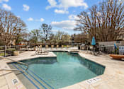 Thumbnail 6 of 30 - A swimming pool with a blue water slide.