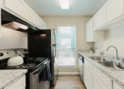 Thumbnail 8 of 26 - black appliance kitchen in north houston apartments