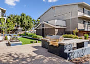 Thumbnail 6 of 29 - A modern house with a patio and a hot tub.