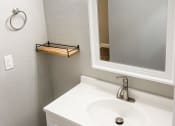 Thumbnail 12 of 19 - a small bathroom with a sink and a mirror