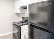 Thumbnail 4 of 19 - a kitchen with stainless steel appliances and white cabinets