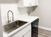 Thumbnail 3 of 19 - an empty kitchen with white cabinets and a sink