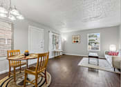 Thumbnail 10 of 22 - A dining room with a wooden table and chairs.