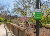 Thumbnail 11 of 17 - a wooden bridge in a park with a sign that reads