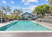 Thumbnail 19 of 22 - a swimming pool with a house in the background