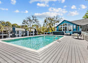 Thumbnail 18 of 22 - a swimming pool with a house in the background