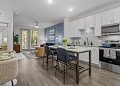 Thumbnail 37 of 41 - A modern kitchen with a dining area.