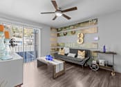 Thumbnail 3 of 22 - a living room with a couch and a ceiling fan