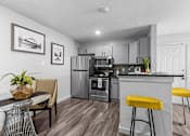 Thumbnail 1 of 22 - our apartments offer a kitchen and living room with stainless steel appliances