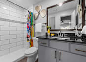 Thumbnail 7 of 22 - a bathroom with a sink toilet and a mirror