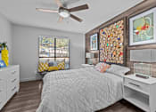 Thumbnail 6 of 22 - a bedroom with a bed and a ceiling fan