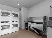 Thumbnail 15 of 22 - a kitchen with appliances and a bed and a refrigerator