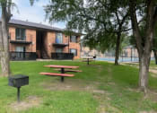 Thumbnail 32 of 36 - a picnic area in front of a building with a pool