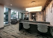 Thumbnail 13 of 26 - A modern office with a long table and chairs.