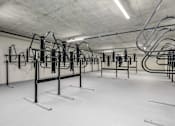 Thumbnail 23 of 26 - A gym with a row of exercise bikes.